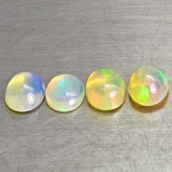 Natural Multi-Color Opal 3.05 Ct. 4 Pcs Oval Cabochon Shape 7.9 x 6 Mm. Unheated Gemstone: Product ID: 818728044 Product Name: Natural Opal Weight: 3.05 CT. Size: 7.9 x 6 x 4.4 MM. Shape: Oval Cabochon Color: Multi-Color Clarity:Semi - Transparent Luster: Good Gems Origin: Ethiopia Treatmen