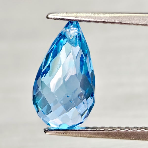 Natural Swiss Blue Topaz 3.99 Ct. Briolette with Drilled 11.5 x 6.6 Mm Gemstone From Brazil: Product ID: 807168055 Product Name: Natural Blue Topaz Weight: 3.99 CT. Size: 11.5 x 6.6 x 6.6 MM. Shape: Briolette With Drilled Color: Swiss Blue Clarity:VSI Luster: Good Gems Origin: Brazil Treatmen