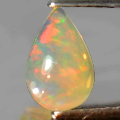 Natural Multi Color Play Of Colour Opal 0.47 Ct. Pear Shape 7.8 x 5.2 Mm Gemstone From Ethiopia: Product ID: 818726350 Product Name: Natural Opal Weight: 0.47 CT. Size: 7.8 x 5.2 x 3.1 MM. Shape: Pear Cabochon Color: Multi Color Clarity:Semi - Transparent Luster: Iridescent Gems Origin: Ethiopia