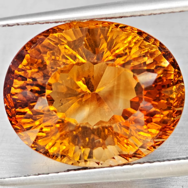 Natural Imperial Topaz 15.59 Ct. Oval Concave Cut 15.6 x 12.8 Mm Gemstone From Brazil: Product ID: 807168617 Product Name: Natural Topaz Weight: 15.59 CT. Size: 15.6 x 12.8 x 10.9 MM. Shape: Oval Shape Color: Imperial Clarity:VSI Luster: Good Gems Origin: Brazil Treatment: Treated Cryst