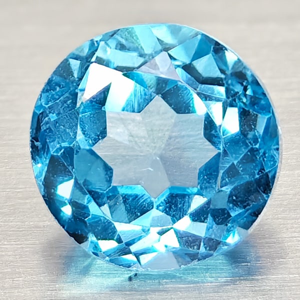 Natural Swiss Blue Topaz 1.63 Ct. Round Shape 6.6 Mm. Gemstone From Brazil: Product ID: 807168106 Product Name: Natural Blue Topaz Weight: 1.63 CT. Size: 6.6 x 6.6 x 4.8 MM. Shape: Round Shape Color: Swiss Blue Clarity:VSI Luster: Good Gems Origin: Brazil Treatment: Treated C