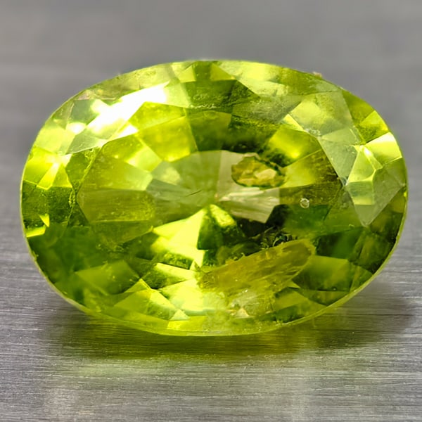 Natural Green Peridot 0.78 Ct. Oval Shape 6.8 x 5 Mm Gemstone From Thailand: Product ID: 105300617 Product Name: Natural Peridot Weight: 0.78 CT. Size: 6.8 x 5 x 3.5 MM. Shape: Oval Color: Green Clarity:VSI Luster: Good Gems Origin: Thailand Treatment: Unheated Crystal Structu