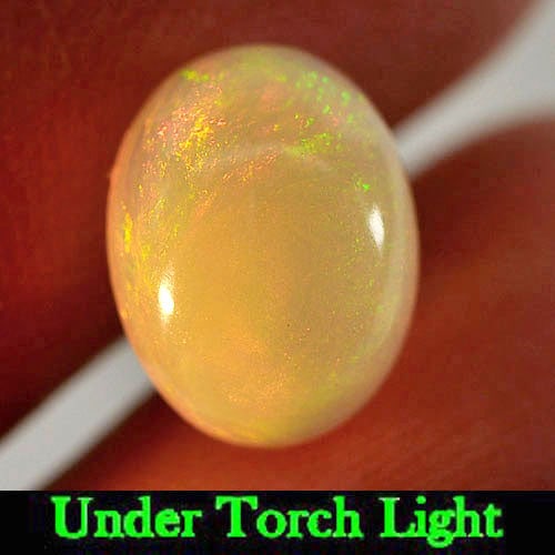 Natural Multi Color Opal 1.28 Ct. Oval Cabochon Shape 9 x 7 Mm. Gemstone: Product ID: 818724064 Product Name: Natural Opal Weight: 1.28 CT. Size: 9 x 7 x 4 MM. Shape: Oval Cabochon Color: Multi Color Clarity:Semi - Transparent Luster: Strong Iridescent Gems Origin: Ethiopia