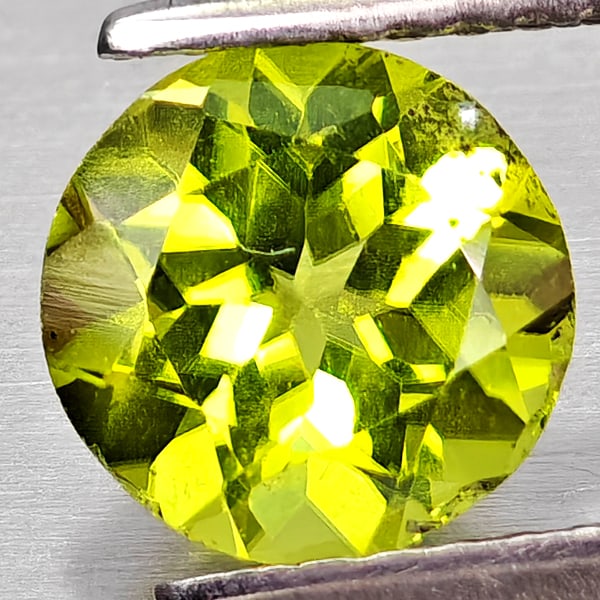 Natural Green Peridot 1.28 Ct. Round Shape 7 Mm. Gemstone From Pakistan: Product ID: 805317206 Product Name: Natural Peridot Weight: 1.28 CT. Size: 7 x 7 x 4.2 MM. Shape: Round Color: Green Clarity:VSI Luster: Good Gems Origin: Pakistan Treatment: Unheated Crystal Structur