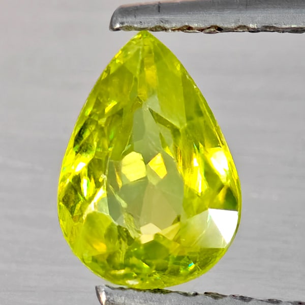 Natural Multi-Color Sphene With Rainbow Spark 1.09 Ct. Pear Shape 8 x 5.8 Mm Gemstone From: Product ID: 806509168 Product Name: Natural Sphene Weight: 1.09 CT. Size: 8 x 5.8 x 3.5 MM. Shape: Pear Shape Color: Multi-Color With Rainbow Spark Clarity:SI1 Luster: Good Gems Origin: Madagascar Tre