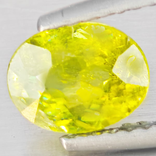 Natural Multi-Color With Rainbow Spark Sphene 1.28 Ct. Oval Shape 7.5 x 5.8 Mm Gemstone From: Product ID: 806509174 Product Name: Natural Sphene Weight: 1.28 CT. Size: 7.5 x 5.8 x 3.8 MM. Shape: Oval Shape Color: Multi-Color With Rainbow Spark Clarity:SI1 Luster: Good Gems Origin: Madagascar T