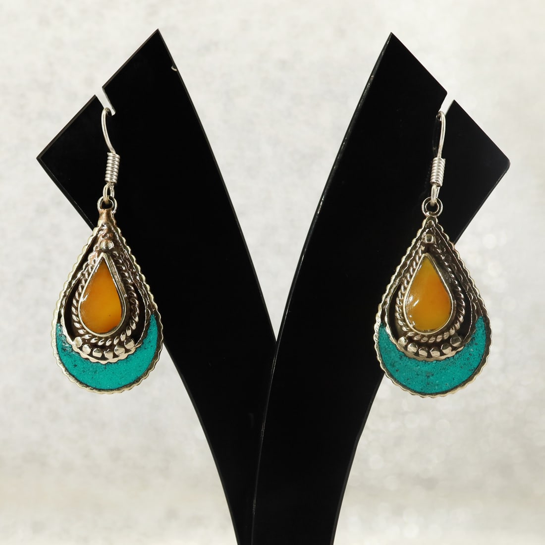 Tibetan Turquoise & Copal Handmade Hippie Earring: Product ID: 250822152736 Product - Tibetan Handmade Earring Gemstone - Natural Turquoise & Copal Size - 3 Cm Weight - 8 Gram Metal - Brass & Copper mix Metal Origin - Nepal Country/Region of Manufactu