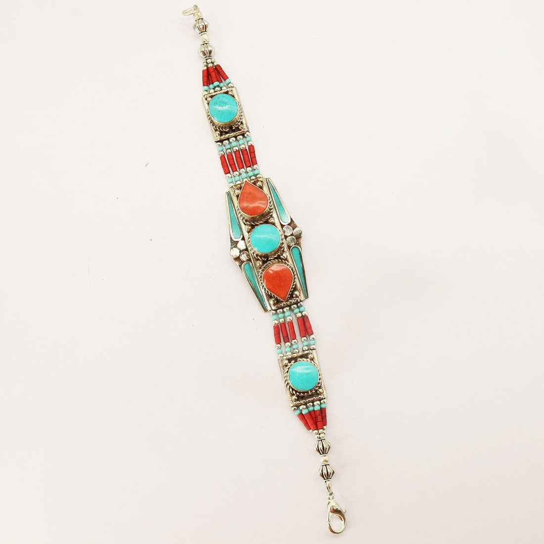 Tibetan Turquoise Handmade Designer Bracelet: Product ID: 250810173733 Product - Tibetan Handmade Bracelet Gemstone - Natural Turquoise & Coral Size - 7 Inch Weight - 30 Gram Approx Metal - Brass & Copper mix Metal Origin - Nepal Country/Region o