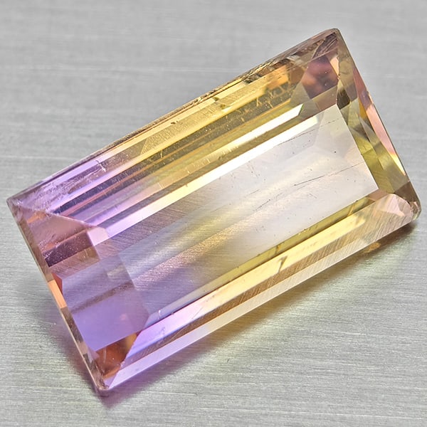 Natural Bi Color Ametrine 4.13 Ct. Baguette Shape 13.1 x 7.2 Mm Gemstone From Bolivia: Product ID: 800408455 Product Name: Natural Ametrine Weight: 4.13 CT. Size: 13.1 x 7.2 x 5.4 MM. Shape: Baguette Color: Bi Color Clarity:VSI Luster: Good Gems Origin: Bolivia Treatment: Unheated Cryst
