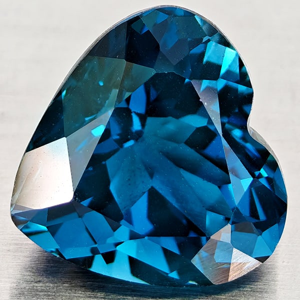 Natural London Blue Topaz 5.86 Ct. Heart Shape 10.7 x 10.3 Mm Gemstone From Brazil: Product ID: 807168372 Product Name: Natural Blue Topaz Weight: 5.86 CT. Size: 10.7 x 10.3 x 7.7 MM. Shape: Heart Shape Color: London Blue Clarity:VVS - VSI Luster: Good Gems Origin: Brazil Treatment:
