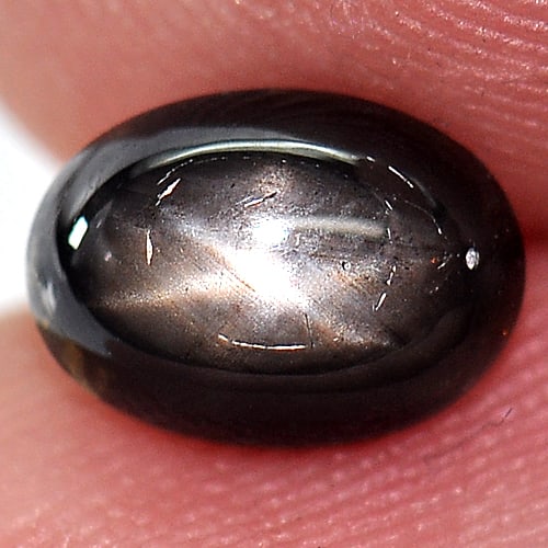 Natural Black Star Sapphire 1.81 Ct. Oval Cabochon Shape 7.5 x 5.4 Mm Gemstone from Thailand: Product ID: 806143271 Product Name: Natural Star Sapphire Weight: 1.81 CT. Size: 7.5 x 5.4 x 3.8 MM. Shape: Oval Cabochon Color: Black Clarity:Opaque Luster: Good 6 Rays Star Gems Origin: Thailand Tre