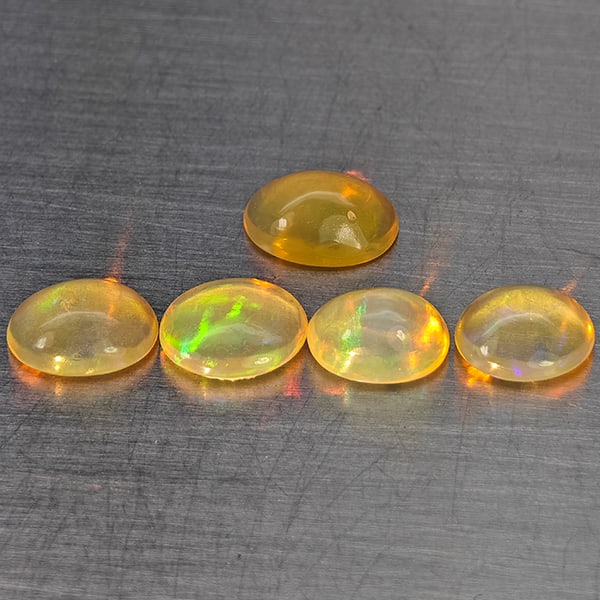 Natural Multi-Color Play Of Colour Opal 2.41 Ct. 5 Pcs Oval Cabochon Shape 7 x 5.1 Mm Gemstones from: Product ID: 818728332 Product Name: Natural Opal Weight: 2.41 CT. Size: 7 x 5.1 x 3.2 to 6.2 x 5.1 x 3.1 MM. Shape: Oval Cabochon Color: Multi-Color Clarity:None Luster: Good Gems Origin: Ethiopia Tre