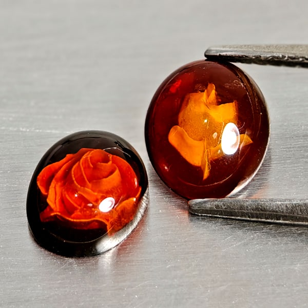 Natural Amber 0.89 Ct. 2 Pcs Flower Carving In Oval Cabochon Shape 8.3 x 7 Mm Gemstones From Poland: Product ID: 819091075 Product Name: Natural Amber Weight: 0.89 CT. Size: 8.3 x 7 x 2.5 MM. Shape: Oval Cabochon Color: Brown Yellow Clarity:Semi - Transparent Luster: Good Gems Origin: Poland Treatmen