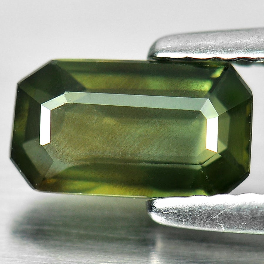 Natural Yellowish Green Sapphire 0.91 Ct. Octagon Shape 7.7 x 4.5 Mm Gemstone From Thailand: Product ID: 806144737 Product Name: Natural Green Sapphire Weight: 0.91 CT. Size: 7.7 x 4.5 x 2.4 MM. Shape: Octagon Color: Green Clarity:SI1 Luster: Good Gems Origin: Thailand Treatment: Heated Cryst