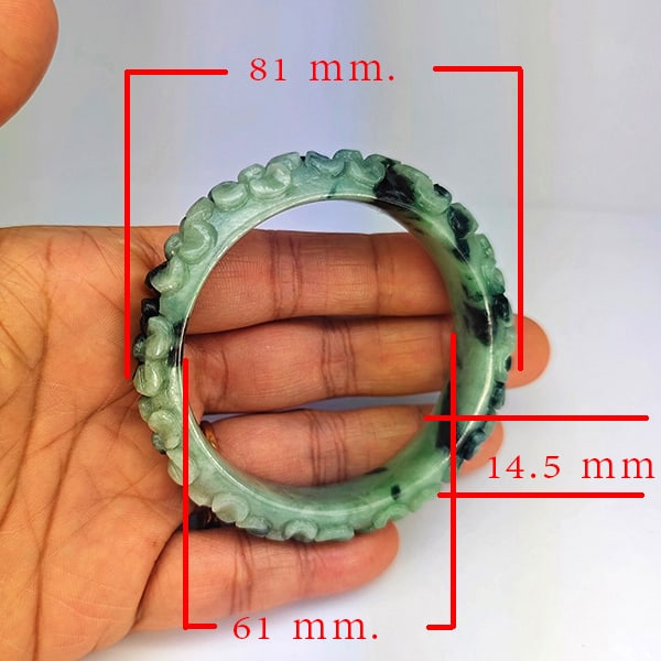 Natural Green Jade Bangle Carving 313.04 Ct. Diameter 60 Mm. Gemstone From Thailand: Product ID: 819816080 Product Name: Natural Jade Weight: 313.04 CT. Size: 81 x 61 x 14.5 MM. Shape: Bangle Round Cabochon Color: Multi-Color Green Clarity:Opaque Luster: Good Gems Origin: Thailand Tre