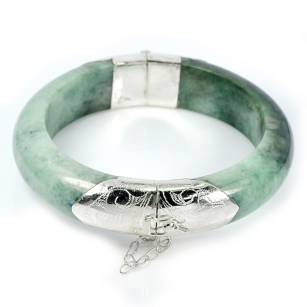 Natural Green Jade 400.00 Ct. Bangle with Silver Diameter 60 Mm. Gemstone From Thailand: Product ID: 819814080 Product Name: Natural Jade Weight: 400.00 CT. Size: 80 x 60 x 15 MM. Shape: Round Cabochon Color: Green Clarity:Opaque Luster: Good Gems Origin: Thailand Treatment: Unheated Crys