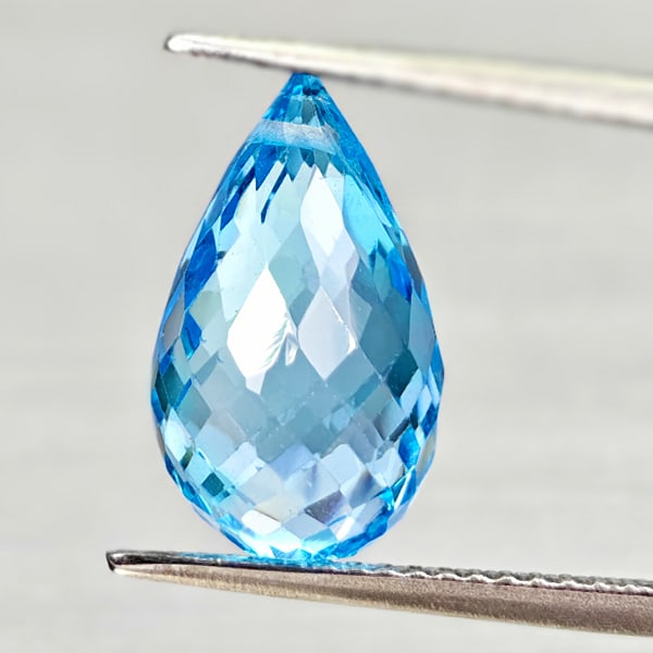 Natural Swiss Blue Topaz 7.34 Ct. Briolette with Drilled Cut 13.9 x 8.3 Mm Gemstone From Brazil: Product ID: 807168051 Product Name: Natural Blue Topaz Weight: 7.34 CT. Size: 13.9 x 8.3 x 8.3 MM. Shape: Briolette With Drilled Color: Swiss Blue Clarity:VSI - SI1 Luster: Good Gems Origin: Brazil Tr