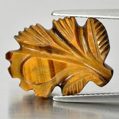 Natural Golden Tiger Eye 8.55 Ct. Leaves Carving Size 18.7 x 13.2 Mm. From Thailand: Product ID: 811600135 Product Name: Natural Tiger eye Weight: 8.55 CT. Size: 18.7 x 13.2 x 5.4 MM. Shape: Carving Leaves Color: Golden Clarity:Opaque Luster: Good Gems Origin: Thailand Treatment: Unhe