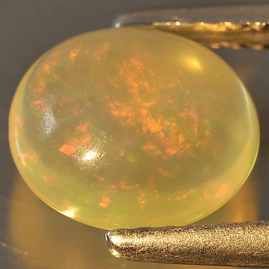 Natural Multi Color Opal 1.11 Ct. Oval Cabochon Shape 8.4 x 7.4 Mm Gemstone From Ethiopia: Product ID: 818714934 Product Name: Natural Opal Weight: 1.11 CT. Size: 8.4 x 7.4 x 4 MM. Shape: Oval Cabochon Color: Multi Color Clarity:Semi - Transparent Luster: Good Gems Origin: Ethiopia Treatmen