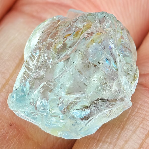 Natural Baby Blue Green Aquamarine 11.27 Ct. Rough Shape 15 x 12.5 Mm Gemstone from Brazil: Product ID: 590800005 Product Name: Natural Aquamarine Weight: 11.27 CT. Size: 15 x 12.5 x 9 MM. Shape: Rough Mixed Shape Color: Baby Blue Green Clarity:None Luster: Good Gems Origin: Brazil Treatment