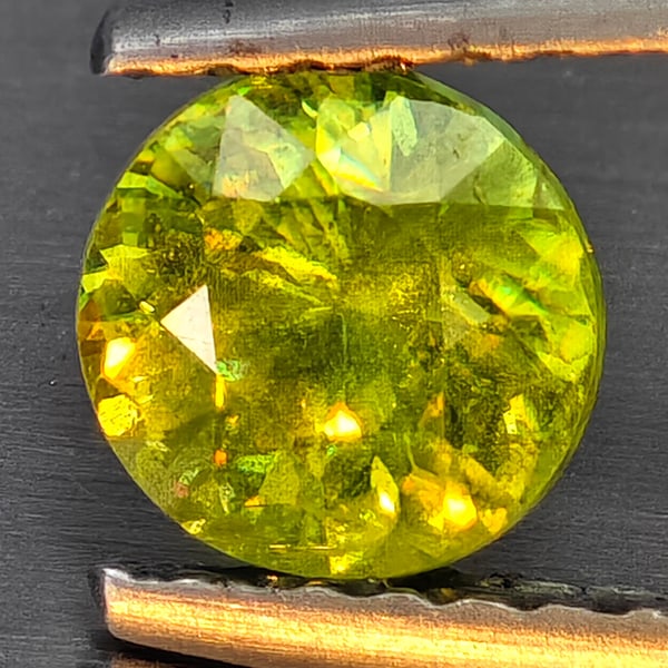 Natural Multi-Color With Rainbow Spark Sphene 0.72 Ct. Round Shape 5.5 Mm Gemstone From Madagascar: Product ID: 806509289 Product Name: Natural Sphene Weight: 0.72 CT. Size: 5.5 x 5.5 x 3.6 MM. Shape: Round Shape Color: Multi-Color Clarity:SI1 Luster: Good Gems Origin: Madagascar Treatment: Unheated