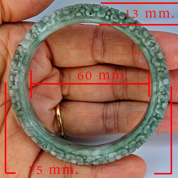 Natural Green Jade Bangle Carving 197.77 Ct. Diameter 60 Mm. Gemstone From Thailand: Product ID: 819816070 Product Name: Natural Jade Weight: 197.77 CT. Size: 75 x 60 x 13 MM. Shape: Bangle Round Cabochon Color: Multi-Color Green Clarity:Opaque Luster: Good Gems Origin: Thailand Treat