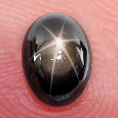 Natural Black Star Sapphire 6 Rays 1.48 Ct. Oval Cabochon Shape 7 x 5.3 Mm. Gemstone: Product ID: 806141308 Product Name: Natural Star Sapphire Weight: 1.48 CT. Size: 7 x 5.3 x 3.5 MM. Shape: Oval Cabochon Color: Black Clarity:Opaque Luster: Good 6 Rays Star Gems Origin: Thailand Treat