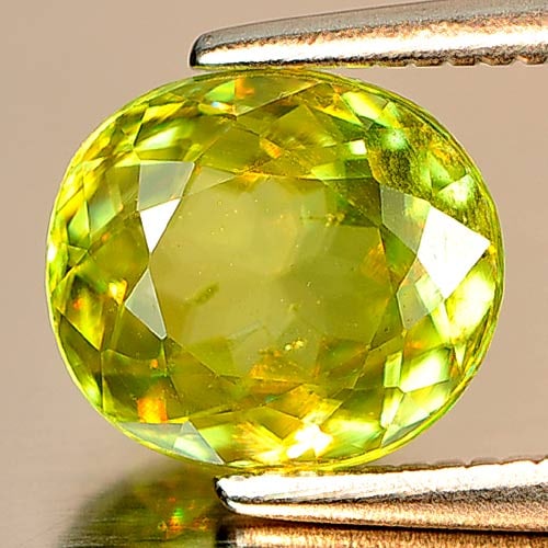 Natural Greenish Yellow Titanium Sphene 1.89 Ct. Oval Shape 7.9 x 7 Mm. Gemstone: Product ID: 806507305 Product Name: Natural Sphene Weight: 1.89 CT. Size: 7.9 x 7 x 4 MM. Shape: Oval Color: Multi Color With Rainbow Spark Clarity:VSI Luster: Adamantine Gems Origin: Madagascar Treat