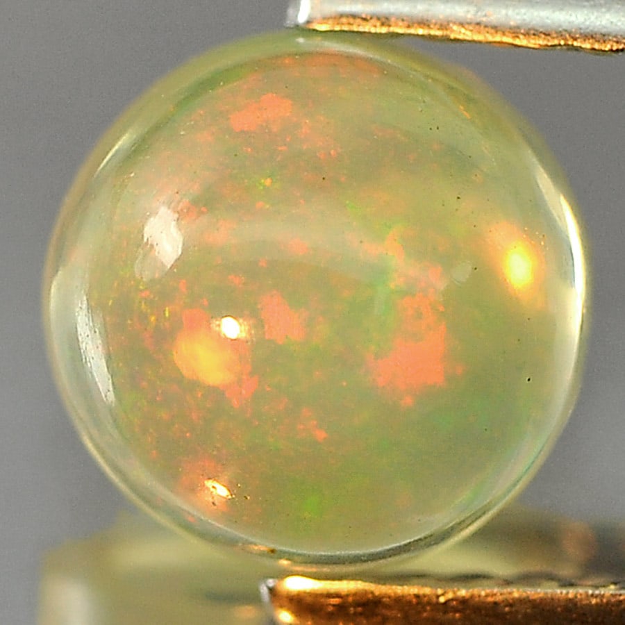 Natural Multi Color Opal 1.30 Ct. Round Cabochon Shape 7.1 Mm Gemstone from Ethiopia: Product ID: 818727123 Product Name: Natural Opal Weight: 1.30 CT. Size: 7.1 x 7.1 x 4.7 MM. Shape: Round Cabochon Color: Multi-Color Clarity:Semi - Transparent Luster: Iridescent Gems Origin: Ethiopia