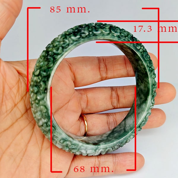 Natural Green Jade Bangle Carving 452.58 Ct. Diameter 68 Mm. Gemstone From Thailand: Product ID: 819816084 Product Name: Natural Jade Weight: 452.58 CT. Size: 85 x 68 x 17.3 MM. Shape: Bangle Round Cabochon Color: Multi-Color Green Clarity:Opaque Luster: Good Gems Origin: Thailand Tre