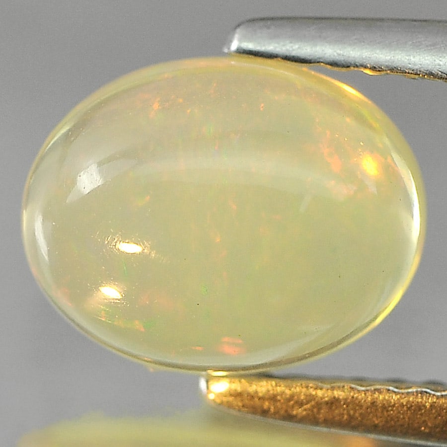 Natural Multi Color Play Of Colour Opal 1.44 Ct. Oval Cabochon Shape 9 x 7.1 Mm Gemstone from: Product ID: 818725224 Product Name: Natural Opal Weight: 1.44 CT. Size: 9 x 7.1 x 4.5 MM. Shape: Oval Cabochon Color: Multi Color Clarity:Semi - Transparent Luster: Iridescent Gems Origin: Ethiopia Tr