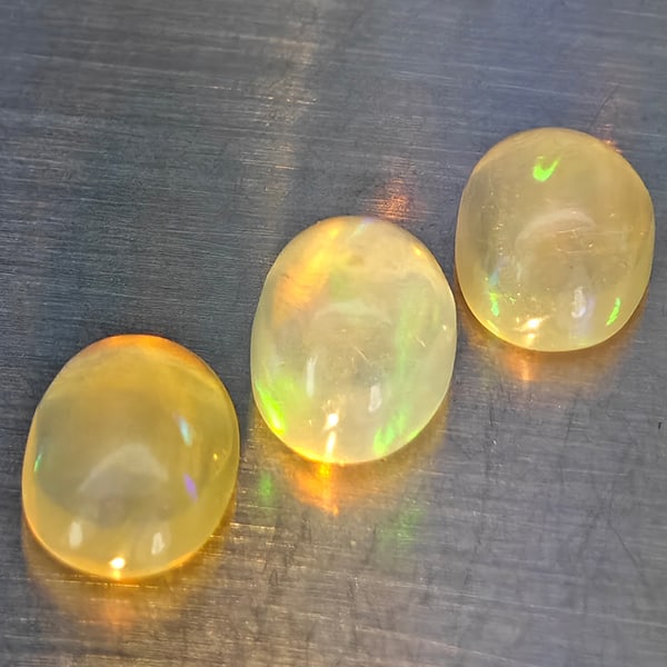 Natural Multi-Color Play Of Colour Opal 2.23 Ct. 3 Pcs Oval Cabochon Shape 7.5 x 5.4 Mm Gemstones: Product ID: 818728308 Product Name: Natural Opal Weight: 2.23 CT. Size: 7.5 x 5.4 x 3.9 MM. Shape: Oval Cabochon Color: Multi-Color Clarity:None Luster: Good Gems Origin: Ethiopia Treatment: Unheated