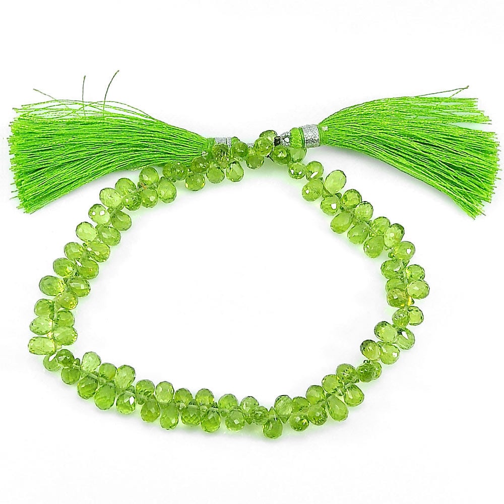 Natural Gemstones Green Peridot Beads 88.30 Ct. Length 9 Inch. Briolette Shape 6.8 x 4.4 Mm.: Product ID: 805306809 Product Name: Natural Peridot Weight: 88.30 CT. Size: 9 Inch. / 6.8 x 4.4 MM. Shape: Briolette Color: Green Clarity:IF - VVS Luster: Good Gems Origin: Thailand Treatment: Unheate