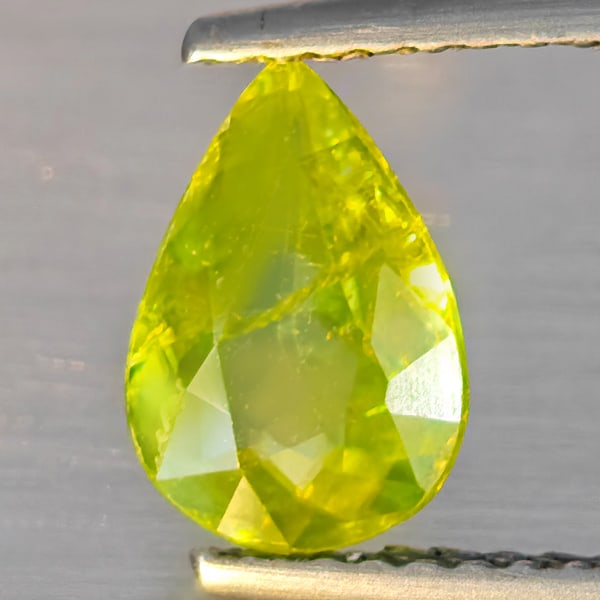 Natural Multi-Color Sphene With Rainbow Spark 1.09Ct. Pear Shape 8.6 x 6 Mm Gemstone From Madagascar: Product ID: 806509166 Product Name: Natural Sphene Weight: 1.09 CT. Size: 8.6 x 6 x 3.2 MM. Shape: Pear Shape Color: Multi-Color With Rainbow Spark Clarity:SI1 Luster: Good Gems Origin: Madagascar Tre