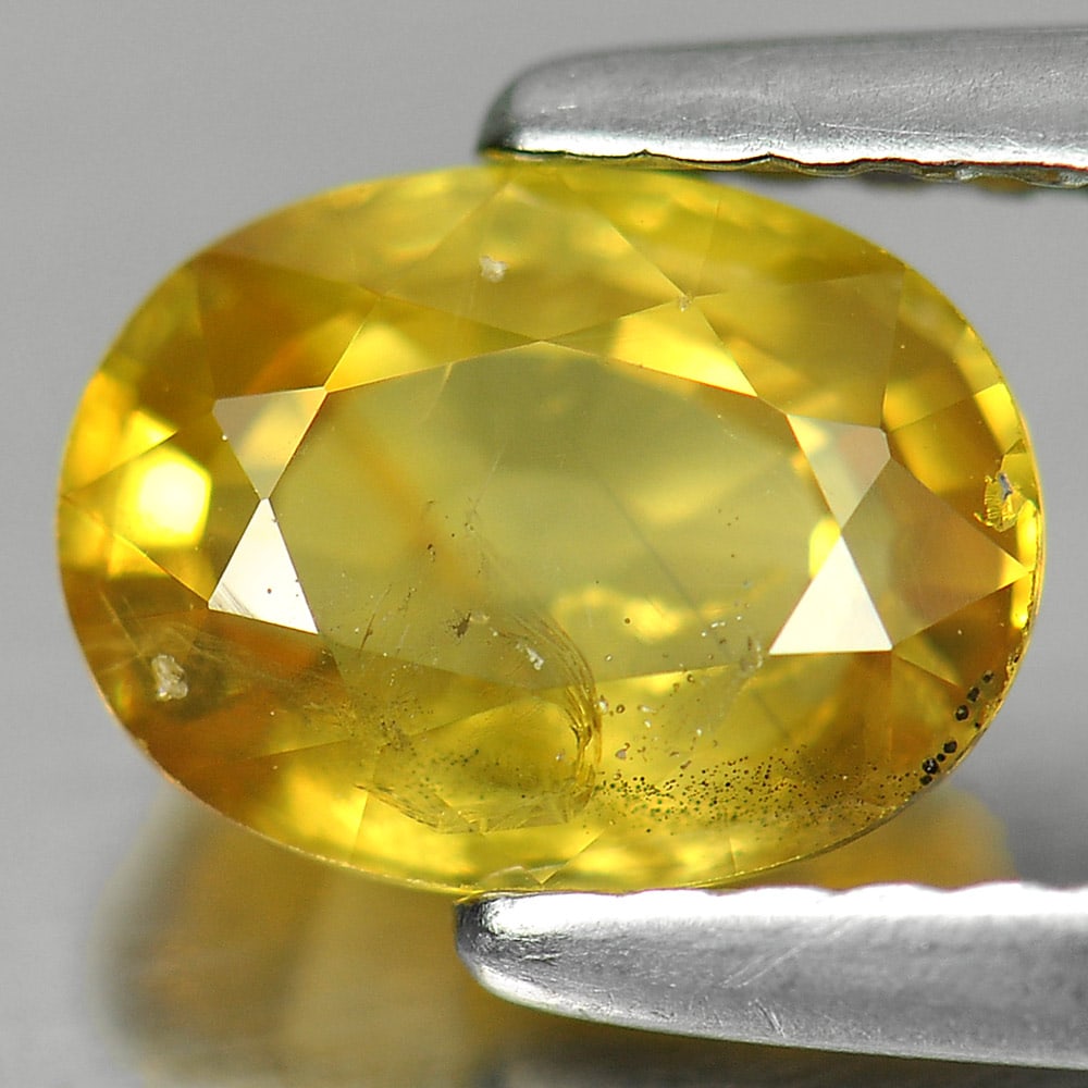 Natural Yellow Sapphire 1.55 Ct. Oval Shape 7.4 x 5.6 Mm. Gemstone From Thailand: Product ID: 806139133 Product Name: Natural Yellow Sapphire Weight: 1.55 CT. Size: 7.4 x 5.6 x 3.8 MM. Shape: Oval Color: Yellow Clarity:SI Luster: Good Gems Origin: Thailand Treatment: Heated Crystal