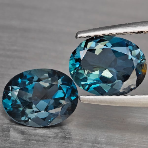 Natural London Blue Topaz 3.94 Ct. 2 Pcs Oval Shape 9 x 7.2 Mm Gemstones From Brazil: Product ID: 807168929 Product Name: Natural Blue Topaz Weight: 3.94 CT. Size: 9 x 7.2 x 4.3 MM. Shape: Oval Color: London Blue Clarity:SI1 Luster: Good Gems Origin: Brazil Treatment: Treated Crystal S