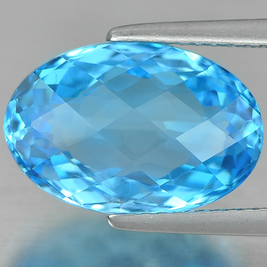 Natural Swiss Blue Topaz 7.06 Ct. Oval Checkerboard Cut 14.3 x 9.5 Mm. Gemstone From Brazil: Product ID: 807142468 Product Name: Natural Blue Topaz Weight: 7.06 CT. Size: 14.3 x 9.5 x 6.5 MM. Shape: Oval Checkerboard Color: Blue Clarity:SI Luster: Good Gems Origin: Brazil Treatment: Treated C