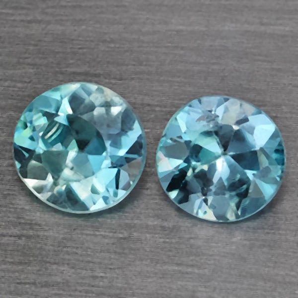 Natural Baby Blue Zircon 0.98 Ct. 2 Pcs Round Diamond Cut 4.8 Mm Gemstone from Cambodia: Product ID: 807743217 Product Name: Natural Zircon Weight: 0.98 CT. Size: 4.8 x 4.8 x 2.7 MM. Shape: Round Diamond Cut Color: Baby Blue Clarity:SI1 Luster: Good Gems Origin: Cambodia Treatment: Heated