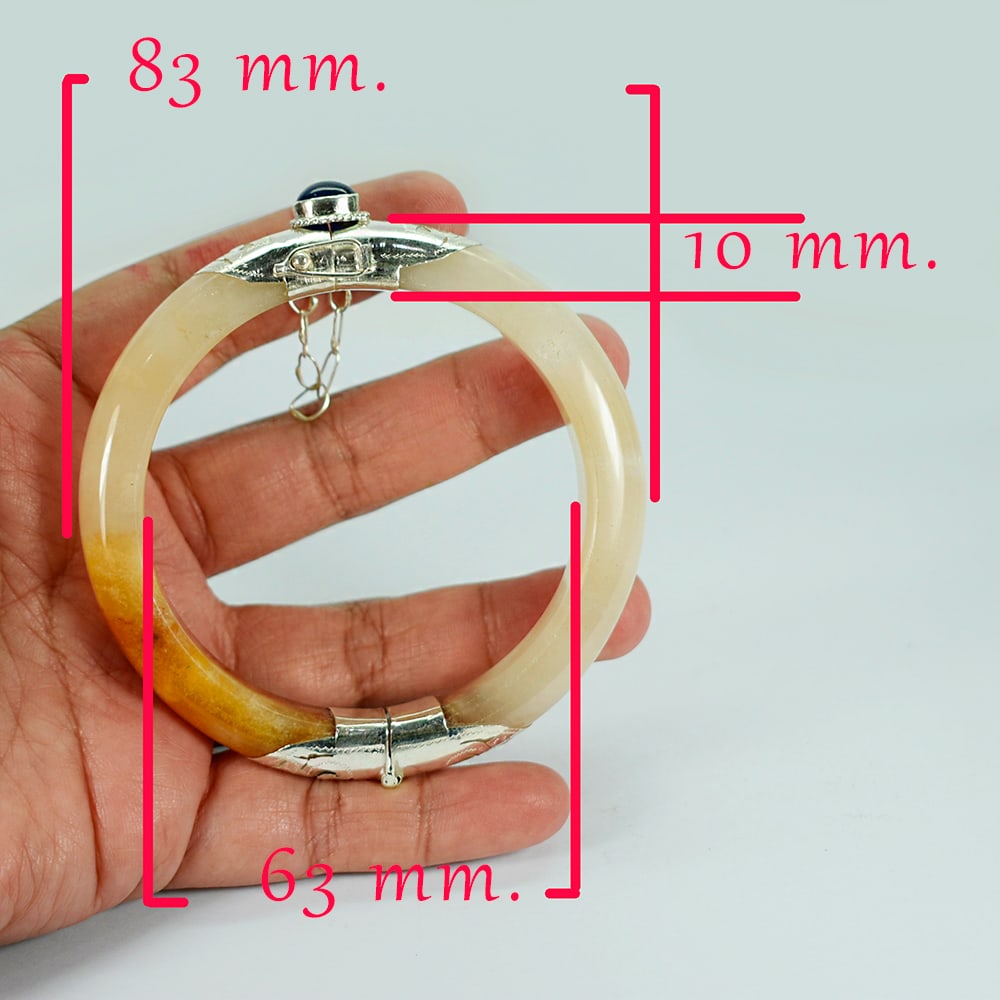 Natural Honey Jade Bangle 321.17 Ct. Diameter 63 Mm. With Silver Jewelry And Natural Blue Sapphire: Product ID: 818102467 Product Name: Natural Gemstones Weight: 321.17 CT. Size: 83 x 63 x 10 MM. Shape: None Color: brown Honey Clarity:Opaque Luster: Good Gems Origin: Burma Treatment: Unheated Crysta