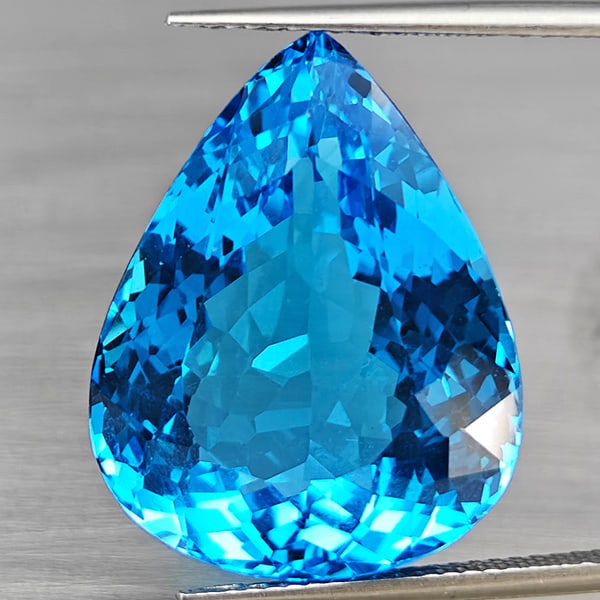Natural Swiss Blue Topaz 32.10 Ct. VVS Pear Shape 22 x 17.8 Mm Gemstone From Brazil: Product ID: 807168692 Product Name: Natural Blue Topaz Weight: 32.10 CT. Size: 22 x 17.8 x 10.8 MM. Shape: Pear Shape Color: Swiss Blue Clarity:VVS Luster: Good Gems Origin: Brazil Treatment: Treated