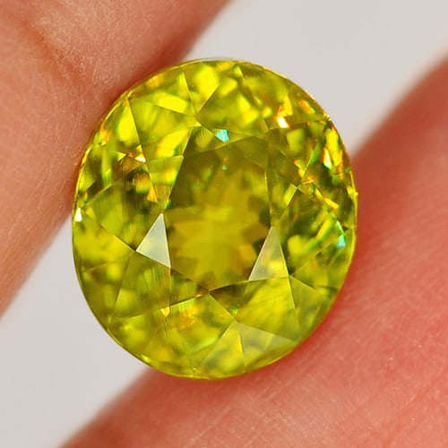 Natural Multi Color Titanium Sphene 5.37 Ct. VVS Oval Shape 10.8 x 9.6 Mm. Unheated Gemstone (1 of 3)