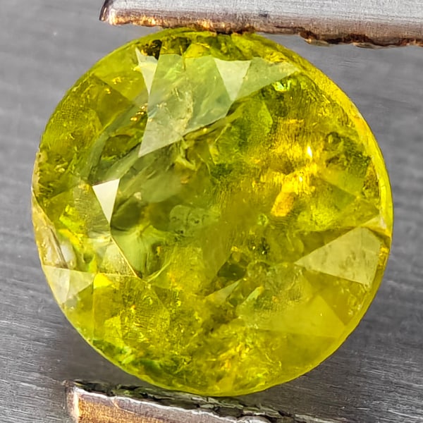 Natural Multi-Color With Rainbow Spark Sphene 0.91 Ct. Round Shape 6 Mm Gemstone From Madagascar: Product ID: 806509254 Product Name: Natural Sphene Weight: 0.91 CT. Size: 6 x 6 x 3.6 MM. Shape: Round Shape Color: Multi-Color Clarity:SI1 Luster: Good Gems Origin: Madagascar Treatment: Unheated Cry