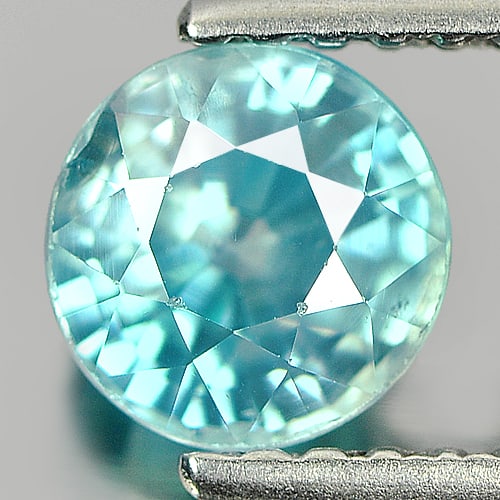 Natural Blue Color Zircon 1.31 Ct. Round Shape 5.7 Mm Gemstone from Cambodia: Product ID: 807720067 Product Name: Natural Zircon Weight: 1.31 CT. Size: 5.7 x 5.7 x 4 MM. Shape: Round Color: Blue Clarity:VSI Luster: Good Gems Origin: Cambodia Treatment: Heated Crystal Structure: