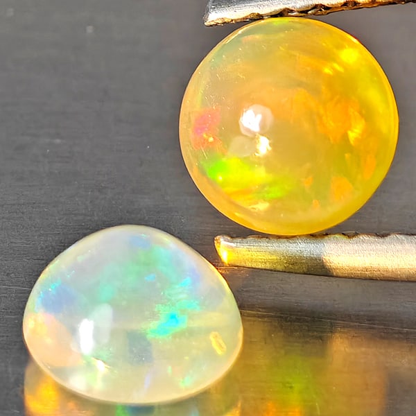 Natural Multi Color Opal 1.17 Ct. 2 Pcs Round Cabochon Shape 5.9 Mm Gemstones From Ethiopia: Product ID: 818728443 Product Name: Natural Opal Weight: 1.17 CT. Size: 5.9 x 5.9 x 4 MM. Shape: Round Cabochon Color: Multi-Color Clarity:Semi - Transparent Luster: Good Gems Origin: Ethiopia Treatme