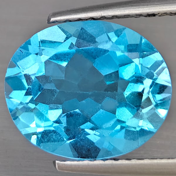 Natural Swiss Blue Topaz 5.08 Ct. Oval Shape 12 x 10.3 Mm Gemstone from Brazil: Product ID: 807169026 Product Name: Natural Blue Topaz Weight: 5.08 CT. Size: 12.2 x 10.3 x 5.7 MM. Shape: Oval Shape Color: Swiss Blue Clarity:VSI Luster: Good Gems Origin: Brazil Treatment: Treated