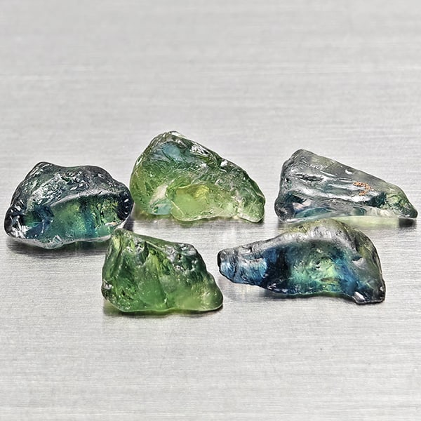 Natural Unheated Greenish Blue Sapphire 4.24 Ct. 5 Pcs Rough Shape Gemstones from Madagascar: Product ID: 806162513 Product Name: Natural Green Sapphire Weight: 4.24 CT. Size: 6.4 x 4.1 x 3.6 to 8.7 x 4.2 x 2.8 MM. Shape: Rough Mixed Shape Color: Greenish Blue Clarity:VSI Luster: Good Gems Ori