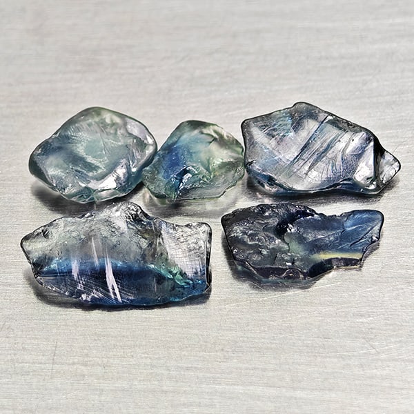 Natural Unheated Greenish Blue Sapphire 3.33 Ct. 5 Pcs Rough Shape Gemstones From Madagascar: Product ID: 806162543 Product Name: Natural Green Sapphire Weight: 3.33 CT. Size: 5.9 x 4.6 x 1.6 to 9.7 x 5.4 x 2.1 MM. Shape: Rough Mixed Shape Color: Greenish Blue Clarity:VSI Luster: Good Gems Ori
