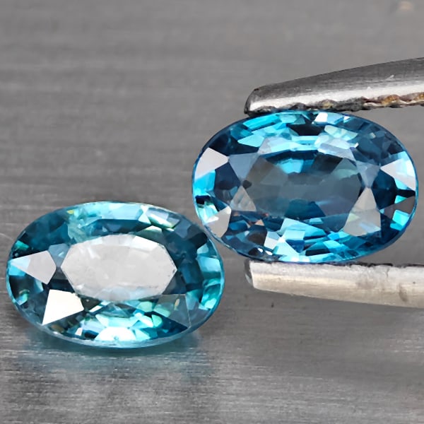 Natural Blue Zircon 1.41 Ct. 2 Pcs Oval Shape 6.1 x 4.1 Mm Gemstone from Cambodia: Product ID: 807725468 Product Name: Natural Zircon Weight: 1.41 CT. Size: 6.1 x 4.1 x 2.8 MM. Shape: Oval Shape Color: Blue Clarity:VSI Luster: Good Gems Origin: Cambodia Treatment: Heated Crystal Str