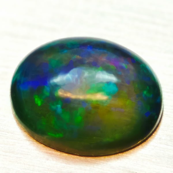 Natural Multi-Color Opal 1.55 Ct. Oval Cabochon Shape 9.2 x 7.2 Mm Gemstone From Ethiopia (1 of 3)