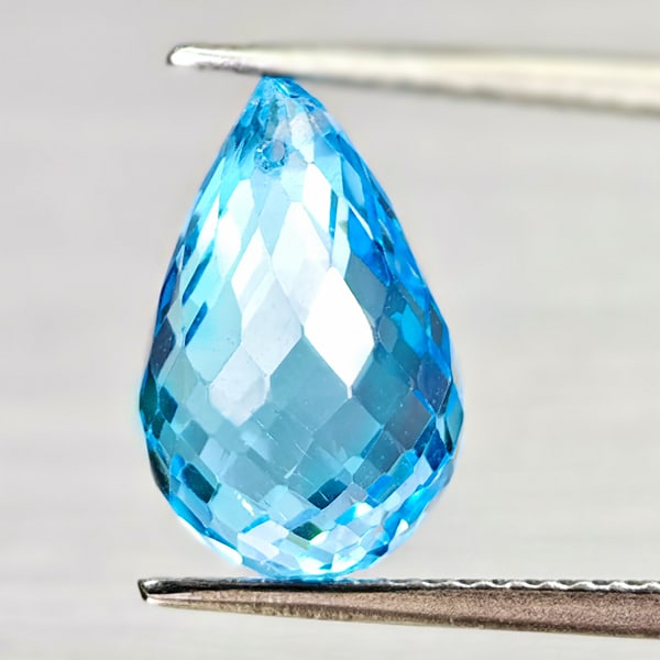 Natural Swiss Blue Topaz 6.97 Ct. Briolette with Drilled 12.9 x 8.3 Mm. Gemstone From Brazil: Product ID: 807168052 Product Name: Natural Blue Topaz Weight: 6.97 CT. Size: 12.9 x 8.3 x 8.3 MM. Shape: Briolette With Drilled Color: Swiss Blue Clarity:VSI Luster: Good Gems Origin: Brazil Treatmen